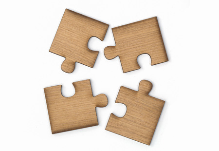 Wooden jigsaw puzzle, pieces of a puzzle, Isolated on White Backgroundの写真素材