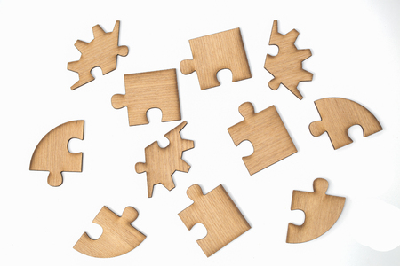 Wooden jigsaw puzzle, pieces of a puzzle, Isolated on White Backgroundの写真素材