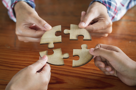 Many persons holding pieces of jigsaw puzzle,Teamwork concept,,Business connection,Success and strategy concept,Business accountingの写真素材