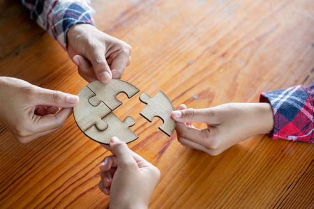 Many persons holding pieces of jigsaw puzzle,Teamwork concept,,Business connection,Success and strategy concept,Business accountingの写真素材