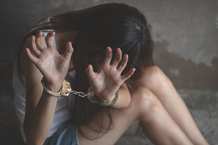 Woman's hands in handcuffs, Stop violence against Women,  human trafficking Concept, international women's day.の写真素材