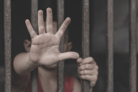 Children are stressed because they are trapped in a steel cage.The concept of violence against children.の写真素材