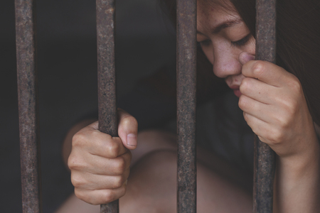 The slave girl  in a cage. Imprisonment, Women violence and abused concept,  human trafficking Concept, international women's day.の写真素材