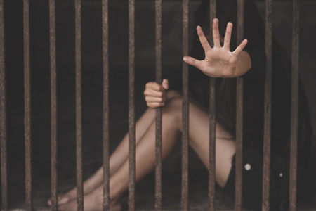 The slave girl  in a cage. Imprisonment, Women violence and abused concept,  human trafficking Concept, international women's day.の写真素材