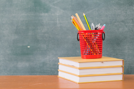 School books on desk, Back to school supplies. Books and blackboard on wooden background, education conceptの写真素材