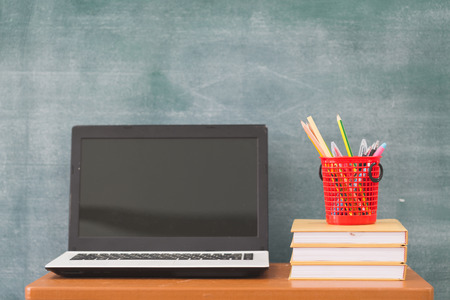 School books on desk, Back to school supplies. Books and blackboard on wooden background, education conceptの写真素材