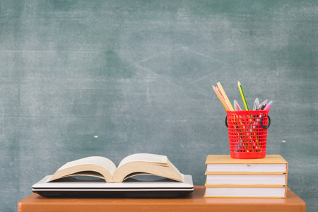 School books on desk, Back to school supplies. Books and blackboard on wooden background, education conceptの写真素材