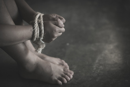 The child hand tied with a rope, Human Rights, Victims of human trafficking,Violence against children, International Anti-Trafficking Dayの写真素材