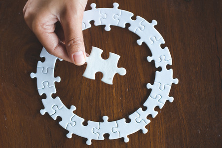 Jigsaw with one piece missing revealing,Comparative conceptの写真素材