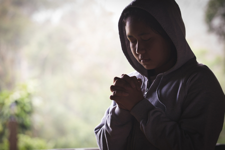 young  human hands praying to god, Christian Religion concept background.の写真素材