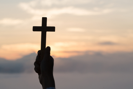 Human hands holding a cross holy and prayed for blessings from God,  Amour Worship God concept. - Imageの写真素材