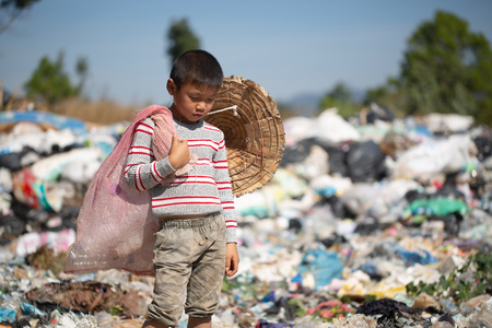 Children find junk for sale and recycle them in landfills, the lives and lifestyles of the poor, Child labor, Poverty and Environment Conceptsの写真素材