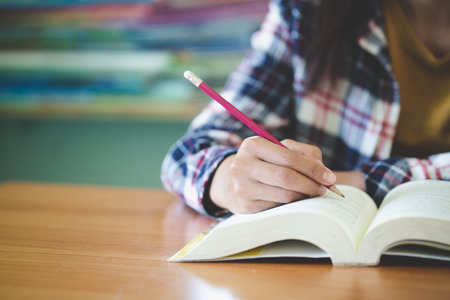 Students write books in the library, Education concept.の写真素材