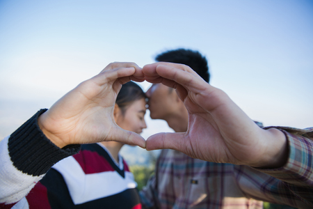 Closeup of couple making heart shape with hands, Happy  in love.の写真素材