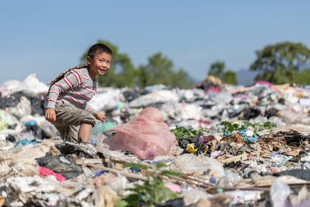 Poor children collect garbage for sale because of poverty, Junk recycle, Child labor, Poverty concept, human trafficking, World Environment Day,の写真素材