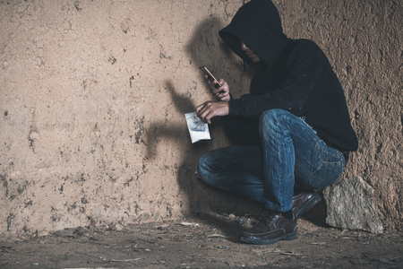 Drug dealer offering narcotic substance,  drug trafficking, crime, addiction and sale concept.の写真素材
