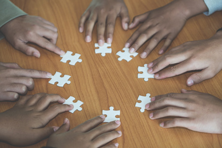Business concept,  Group of business people assembling jigsaw puzzle and represent team support and help togetheの写真素材