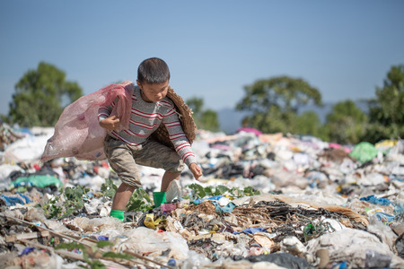 Poor children collect garbage for sale because of poverty, Junk recycle, Child labor, Poverty concept, human trafficking, World Environment Day,の写真素材