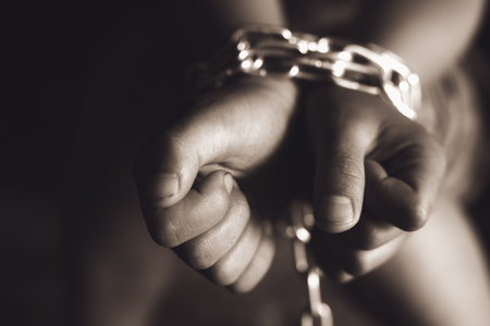 Chain on hand of female prisoners, concept of imprisonment, punishment for offenders , Human trafficking, violence against women, Slave woman, dark tone.の写真素材