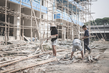 Concept of poverty and child labor, Children who are working on construction sites ,  Against child...