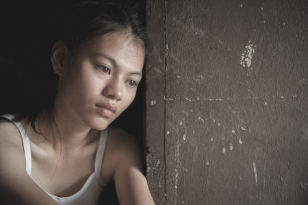 Women sitting on the floor  with depression,  family problems,  Domestic violence, Stop violence and abuse ,sexual abuse, human trafficking,  rape,  The concept of depression and suicide,の写真素材