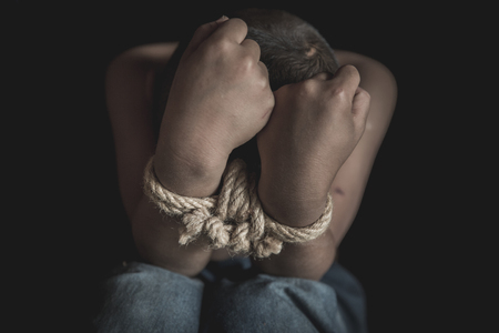hopeless man hands tied together with rope, human trafficking, Stop abusing violence.の写真素材