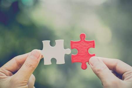 Hand connect white and red jigsaw parts with word problem & solution.   symbol of association and connection. business strategy. Teamwork concept.の写真素材