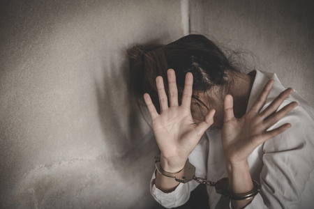 Close up violence crime and kidnapping people concept, criminal tying woman hands with handcuffs,...