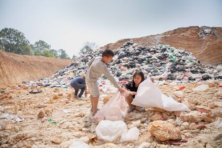 environment Earth Day, A group of children helping to sort waste to be recycled. The concept helps...