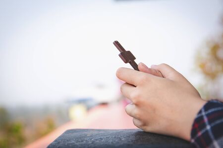 Human hand holds cross. prayer concept for faith, spirituality and religion Christian concept .の写真素材