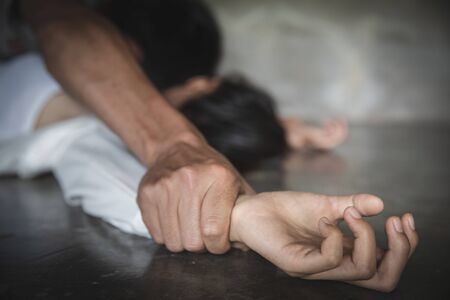Man's hand holding a woman hand for rape and sexual abuse concept, Wound domestic violence rape, concept photo of sexual assault, International Women's Dayの写真素材