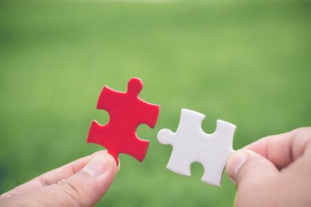 Closeup hand of man connecting jigsaw puzzle, Business solutions, success and strategy concept,...