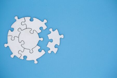 white jigsaw puzzle pieces on blue background, Copy space.の写真素材