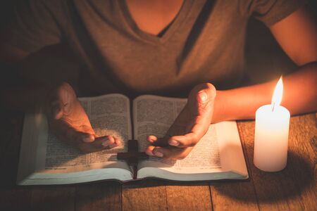 A boy is praying seriously and hopefully to Jesusの写真素材