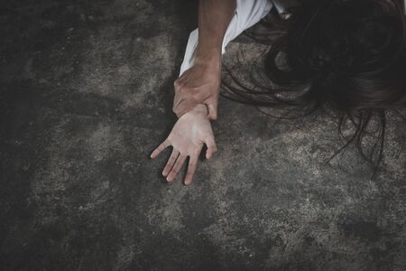 Man's hand holding a woman hand for rape and sexual abuse,  Hands for rape and sexual abuse concept, Sexual abuse is a problem or Social issues concept.の写真素材