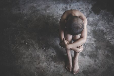 The girl sat depressed in a dark room, Violence against children, Domestic violence,  human trafficking  Concept, stop violence against Women, international women's dayの写真素材