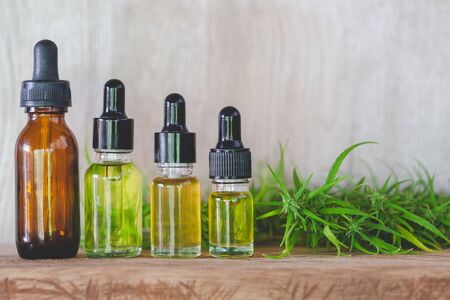 CBD hemp oil  products,  Cannabis oil against Marijuana plant. Herbal Treatment, Alternative Medicineの写真素材