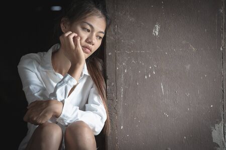 Depressed woman sitting on ground, female in depression sadness, Physically abused woman, The...