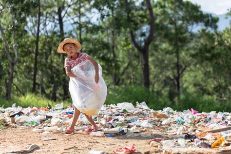 Children find junk for sale and recycle them in landfills, the lives and lifestyles of the poor, Child labor, Poverty and Environment Conceptsの写真素材