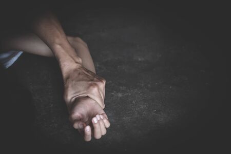 Close up of man hands holding a woman hands for rape and sexual abuse concept, Wound domestic violence rape, sexual assault, stop violence against women, human trafficking.の写真素材