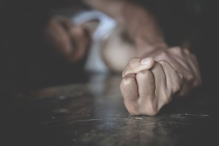 Close up of man hands holding a woman hands for rape and sexual abuse, anti-trafficking and stopping...