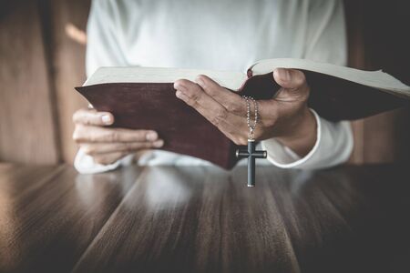 Women hand  pray to God with the Bible and the cross of the morning. Woman Pray for god blessing to wishing have a better life. Christian life crisis prayer to god.の写真素材