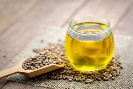 CBD Hemp oil, marijuana plant and cannabis oil on wooden table, medical marijuana oil conceptの写真素材