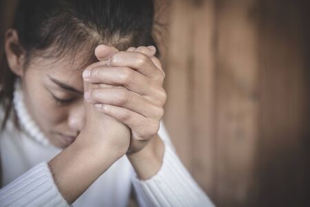 Religious young woman praying to God in the morning, spirtuality and religion, Religious conceptsの写真素材