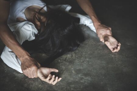 Close up man's hand holding a woman hand for rape and sexual abuse concept.