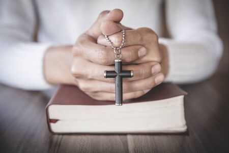 Women pray to God with the Bible and the cross of the morning. Woman Pray for god blessing to wishing have a better life. Christian life crisis prayer to god.の写真素材