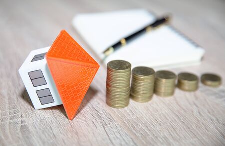 planning savings money of coins to buy a home, concept for property ladder, mortgage and real estate investment. for saving or investment for a house, growing businessの写真素材