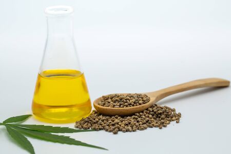 Hemp seeds and hemp oil on white background, CBD cannabis oil extract, marijuana  alternative herbal medicine concept.の写真素材