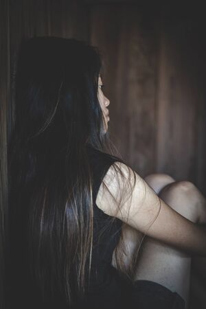 Young depressed woman, domestic and rape violence,beaten and raped sitting in the corner, Domestic violence.の写真素材