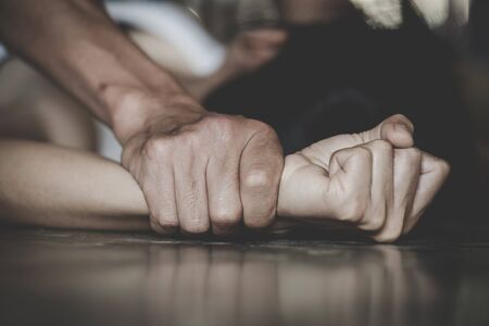 Man's hand holding a woman hand for rape and sexual abuse concept, Wound domestic violence rape,...